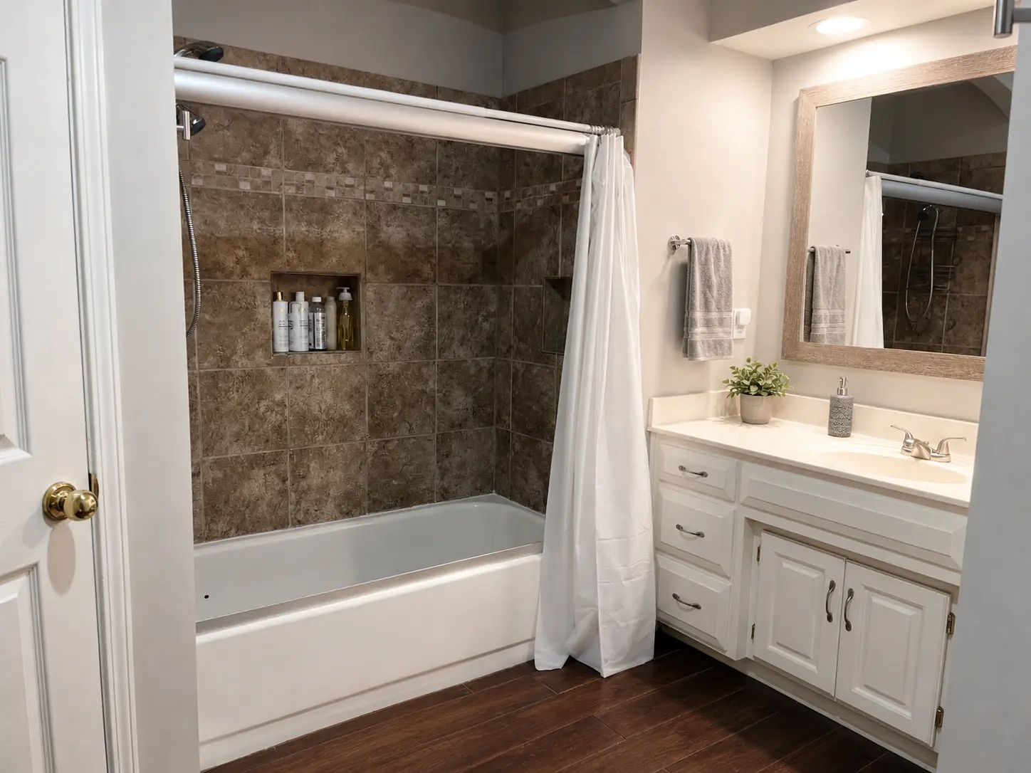 Primary bathroom with corner soaker tub and twin vanities — after