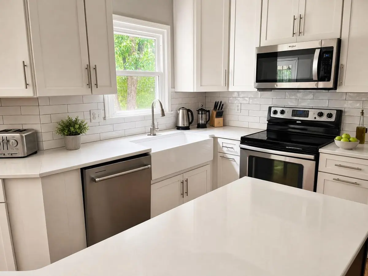Kitchen with farmhouse sink and white cabinets — after